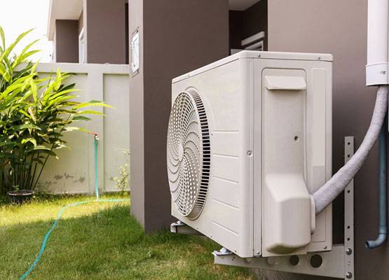 Outdoor residential air conditioning condenser installed beside a home in the Fort Worth area