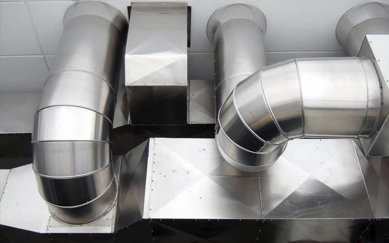 Custom-fabricated sheet metal ductwork elbows built for an HVAC installation in Fort Worth, TX